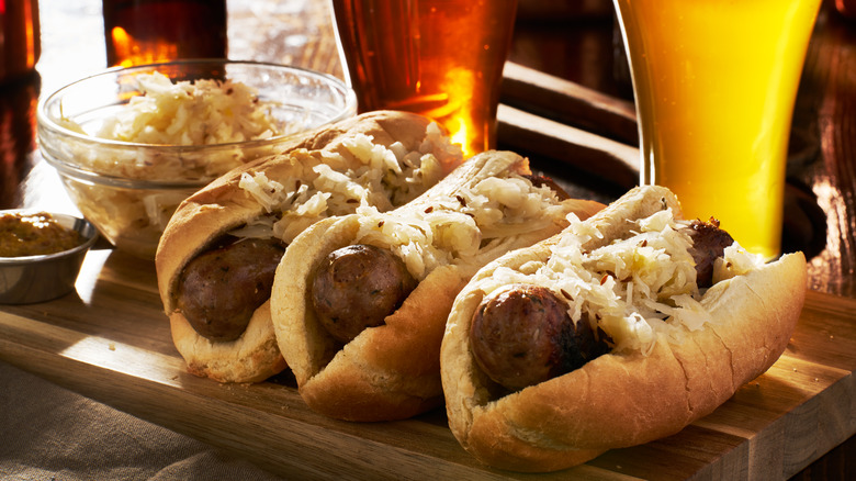 bratwursts in buns with glasses of beer