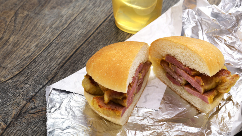 halved peameal bacon sandwich on foil