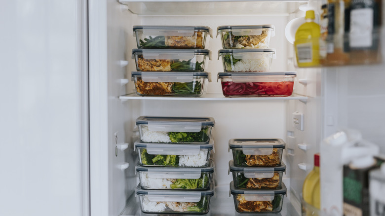 Fridge filled with lunch boxes as part of healthy meal prep.