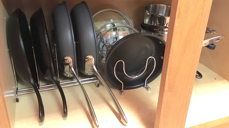 cast iron pans in cupboard