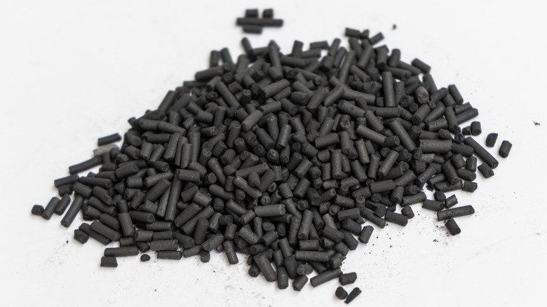 Activated charcoal pellets against a white background