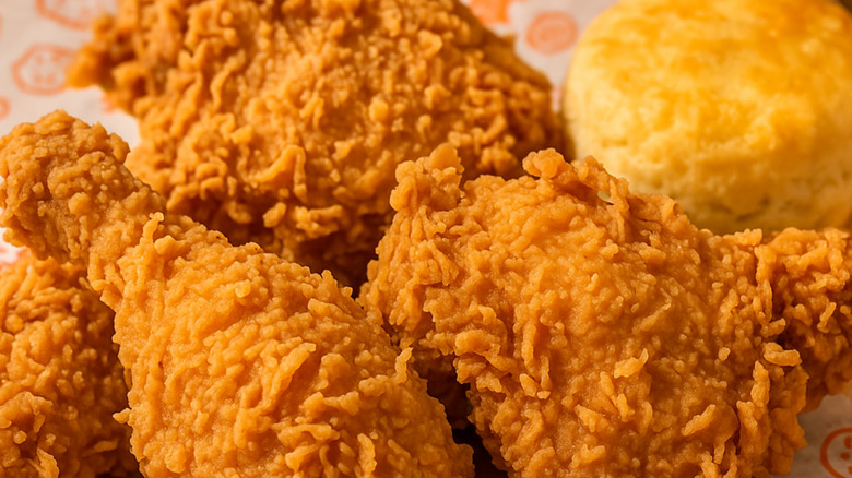 Fried chicken and a biscuit on a plate