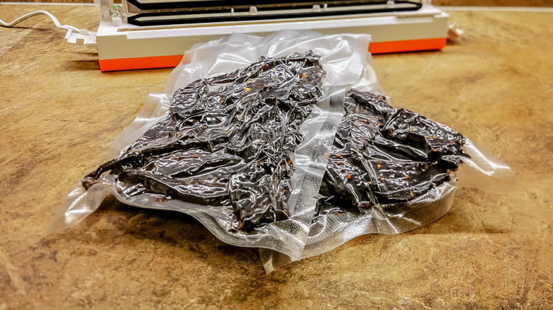 Pieces of beef jerky within vacuum-sealed bags