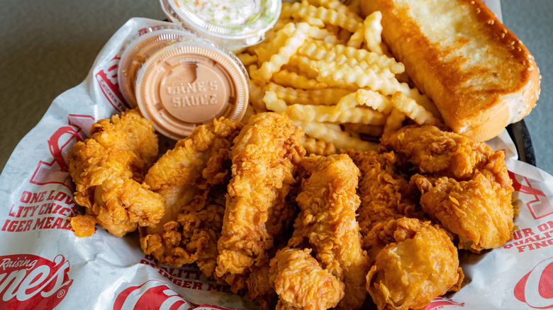 Raising Cane's fried chicken tenders, fries, and Cane's Sauce