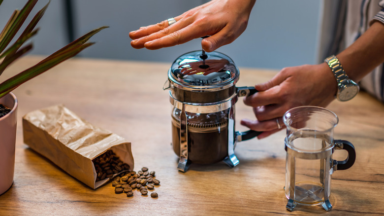 person using a French press