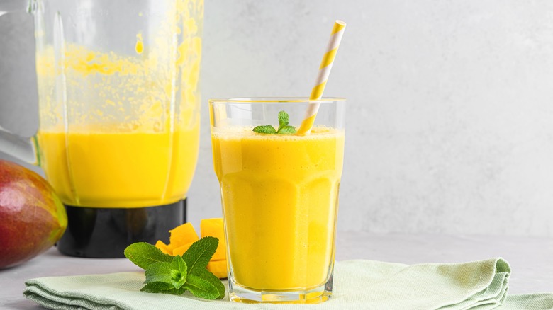 A mango lassi with a blender.