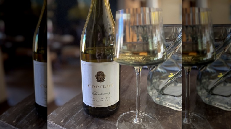 Copilot Chardonnay by wine glass on wooden table
