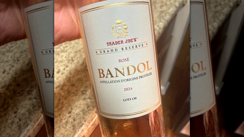Hand holds bottle of Trader Joe's Grand Reserve Bandol Rosé