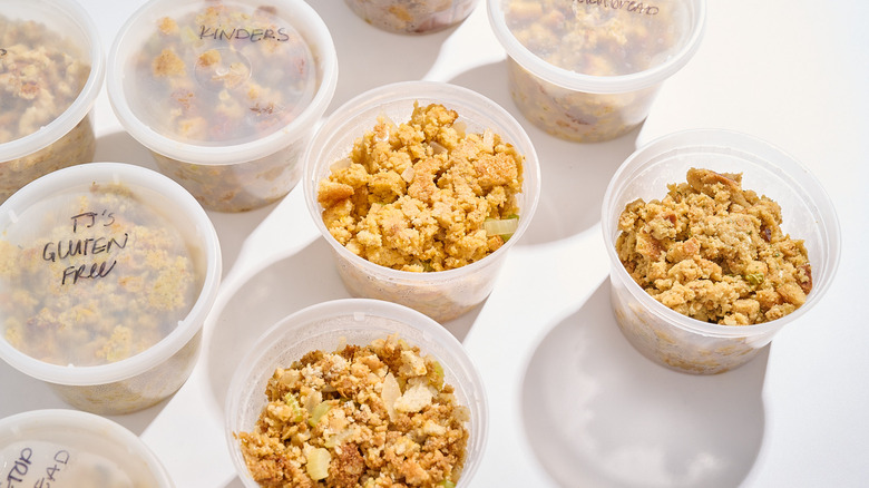 Several stuffing mixes in deli containers on a table