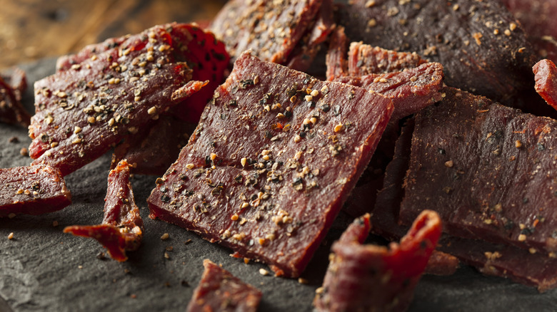 Seasoned beef jerky on a slate serving platter