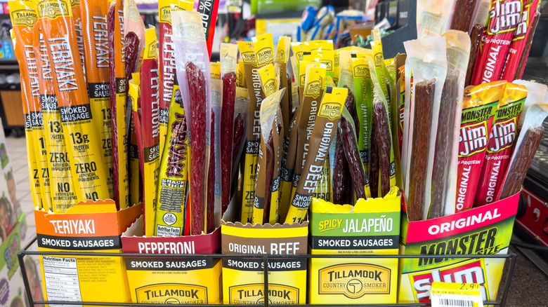 A variety of beef sticks in display at a grocery store