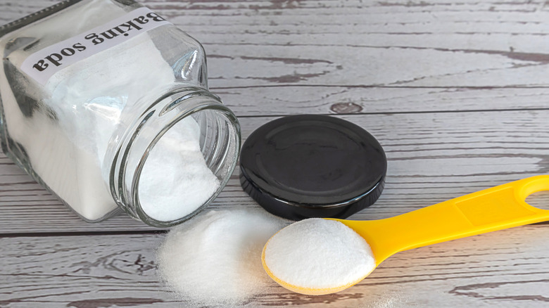 baking soda container open with spoon
