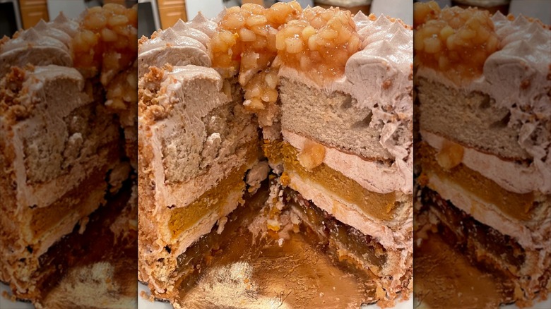 A three-tier piecaken with a large slice cut out of it