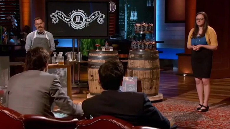 Jess Sanchez McClary and assistant next to vinegar display on Shark Tank