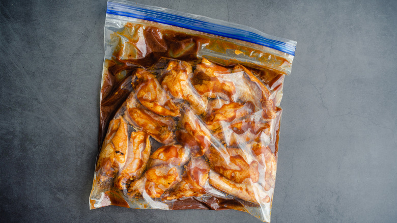 chicken wings marinating in a ziploc bag