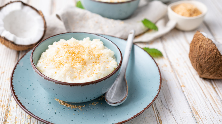 coconut rice pudding with opened coconut in background
