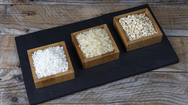 Three different types of rice in square bowls