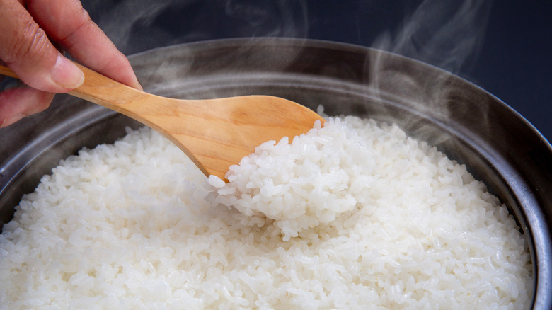 Spoon lifting rice out of pot