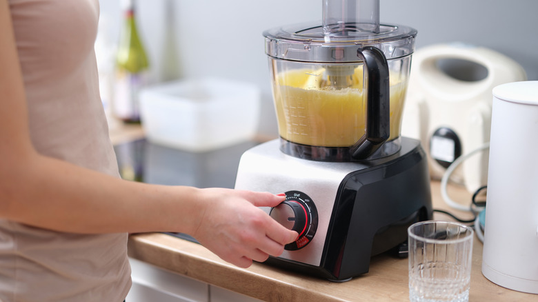 Woman using a food processor