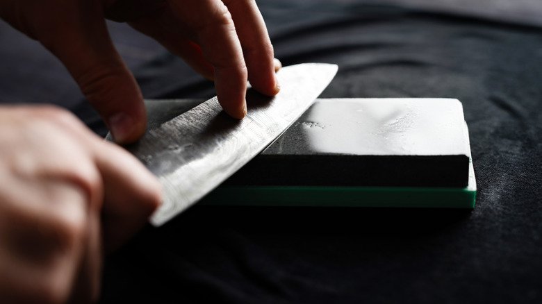 hands sharpening knife
