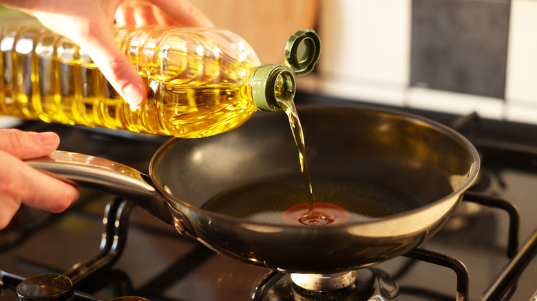 Pouring oil into pan