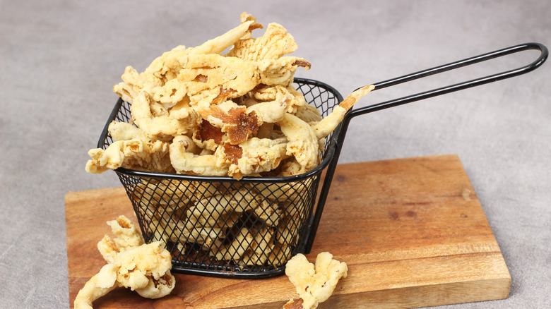 Crispy oyster mushrooms served in a black frying basket
