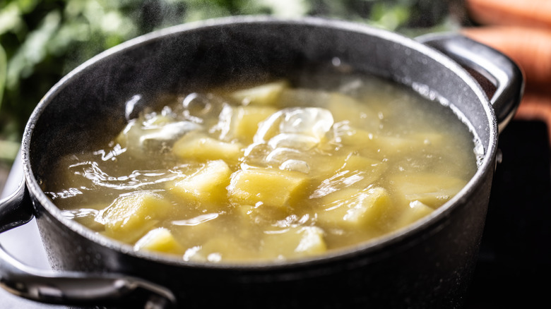 boiling cut potatoes in a pot