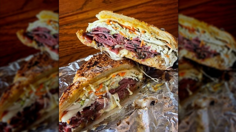 The Chipotle Pastrami sandwich from Sam La Grassa's cut in half on top of foil.