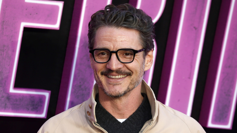Pedro Pascal wearing glasses and smiling