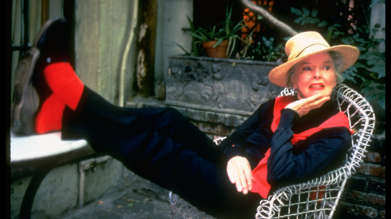 Katharine Hepburn resting on a chair