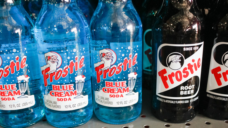 Bottles of Frostie Blue Cream Soda and Frostie Root Beer on store shelf