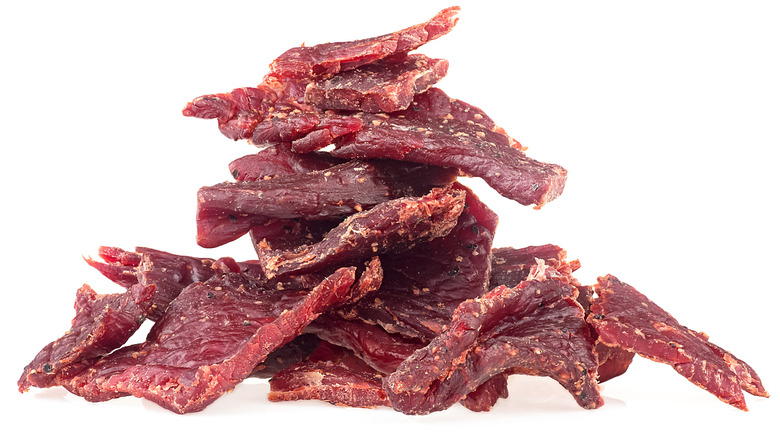 a pile of beef jerky with a white background