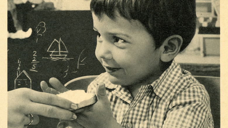 A retro ad of a child being given a slice of bread