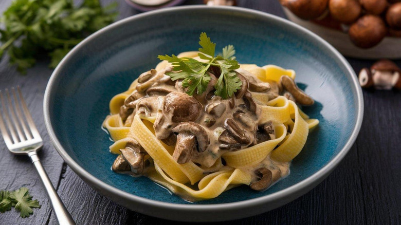 A bowl of pasta in a creamy mushroom-based sauce