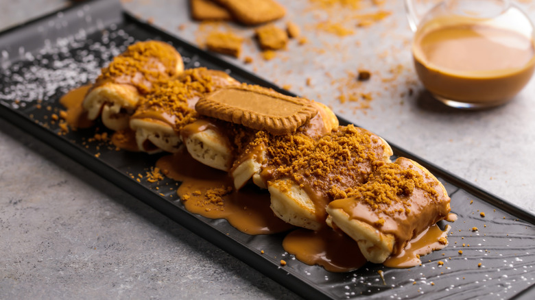 Rolled pancakes topped with cookie butter spread and crushed speculoos.