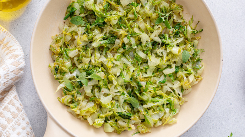 Sauteed green cabbage with herbs in a bowl as a healthy side dish.