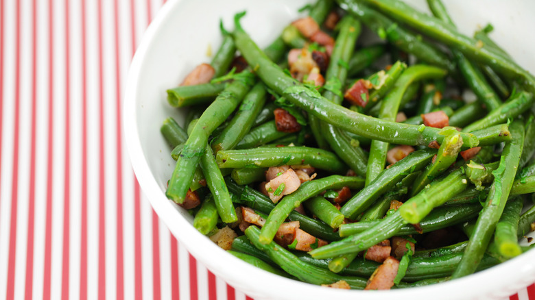 Green bean dish is served in a bowl.