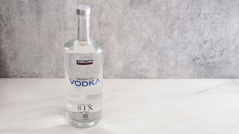 Bottle of Kirkland Signature American Vodka sitting on a marble surface.