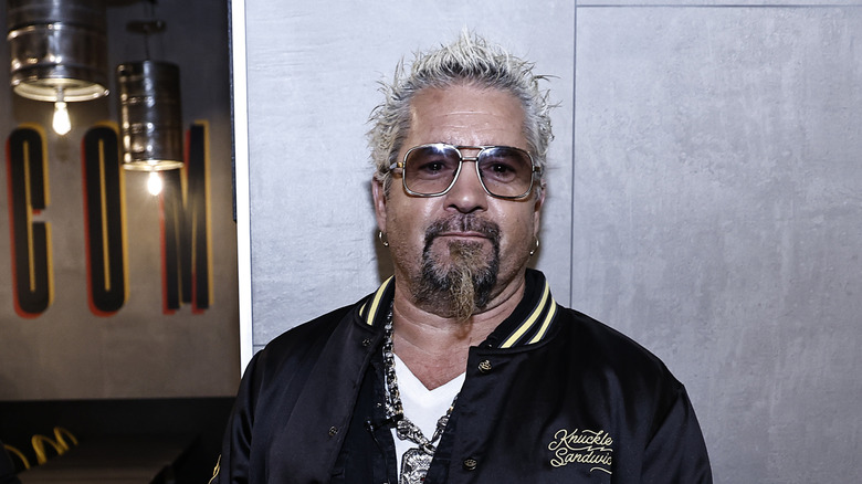 Guy Fieri wearing glasses with Transitions-type lenses