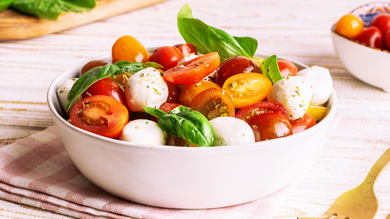 Caprese salad with cherry tomatoes and mozzarella balls in a bowl