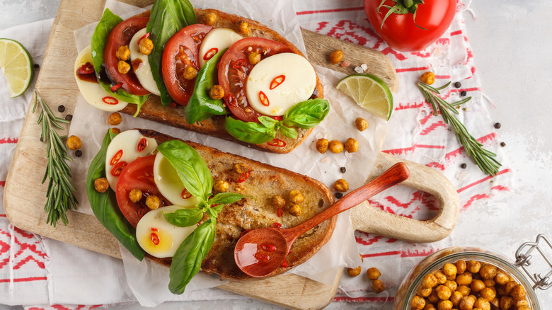 Toast with tomatoes, mozzarella, basil, and crispy chickpeas