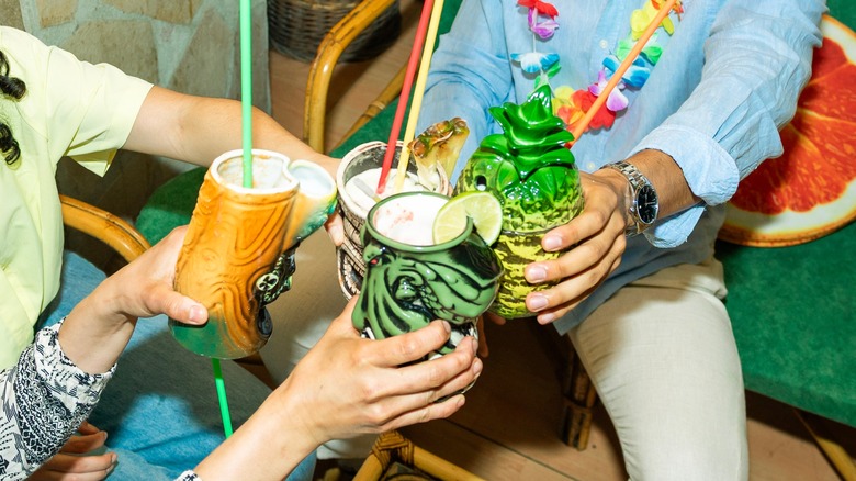 Friends sharing tiki drinks