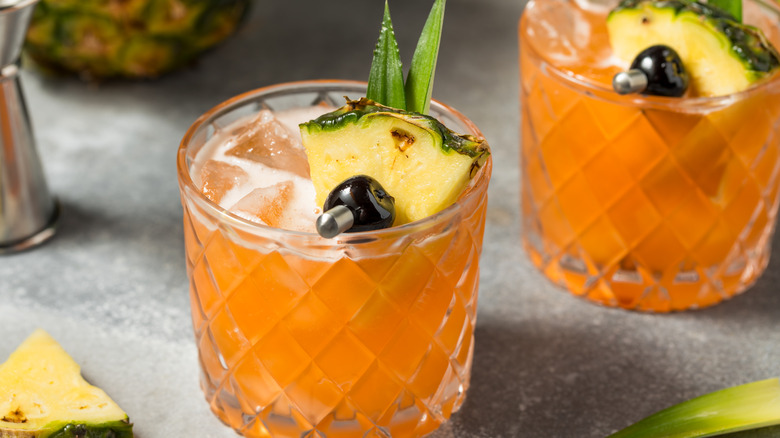 tropical drinks garnished with pineapple