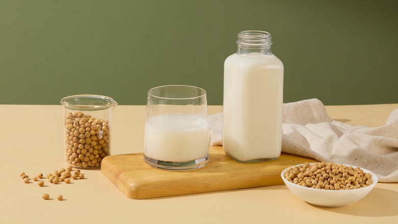 A spread of soy beans and soy milk on a green and tan background