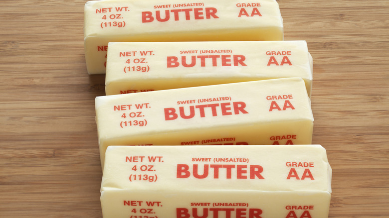 sticks of unsalted butter on a faux-wood countertop