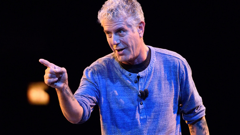 Anthony Bourdain points while speaking at an event
