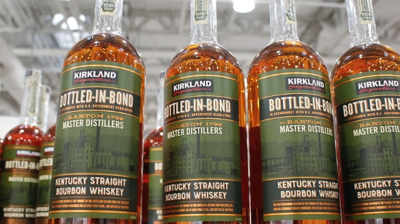 Bottles of Kirkland bottled-in-bond bourbons on a shelf.