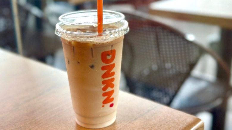 Dunkin' beverage in plastic cup on table