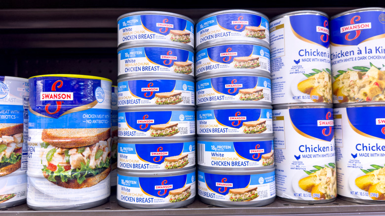 Shelves of canned chicken in a grocery store