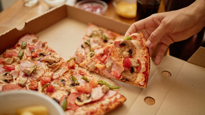 Closeup of fast food pepperoni pizza in delivery box.